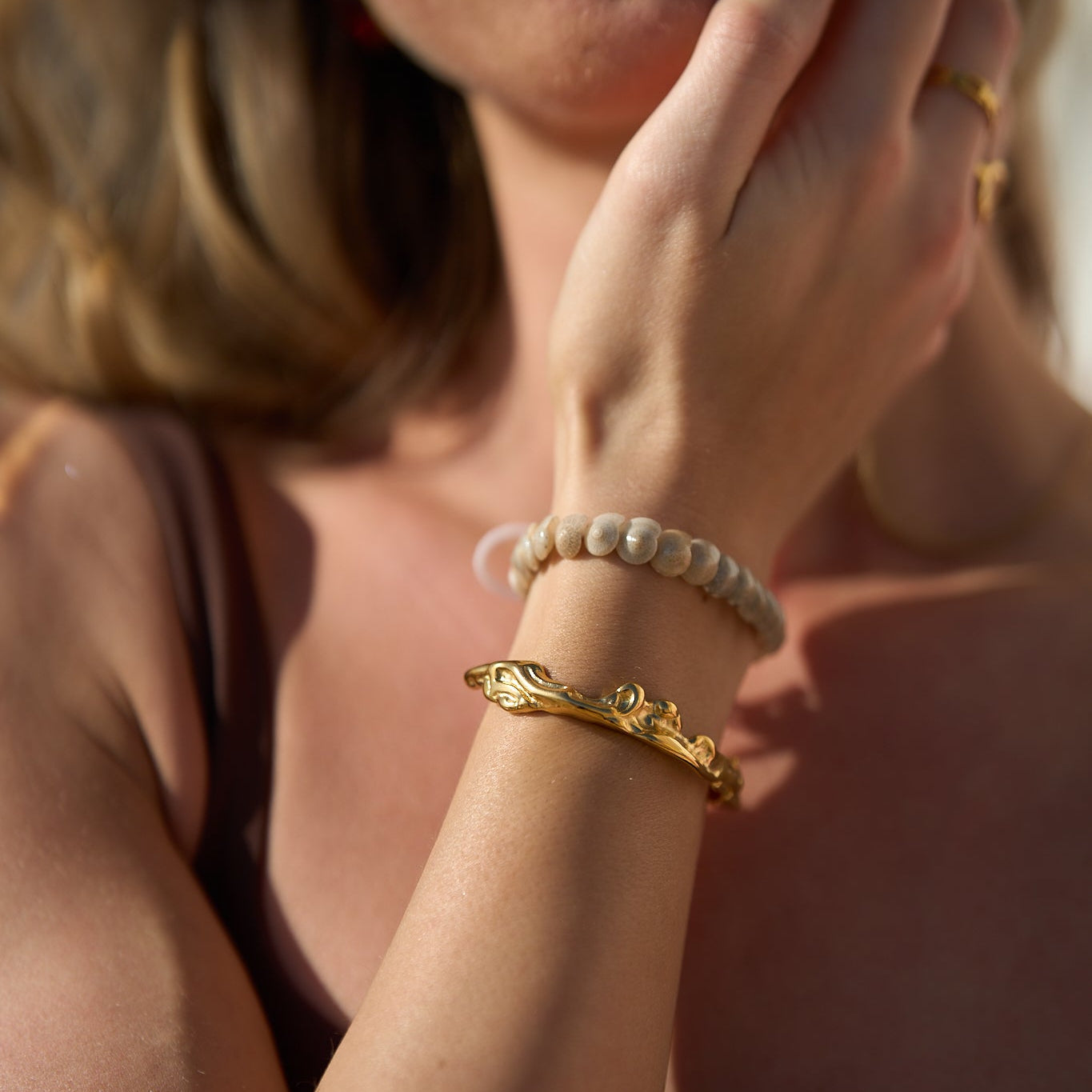 Maria Crunchy Bangle – 18k Gold PVD Plated Stainless Steel – Styled on Model’s Wrist With an Additional Bracelet – Layered Bracelet Styling – Mila Giraldo Jewellery Australia