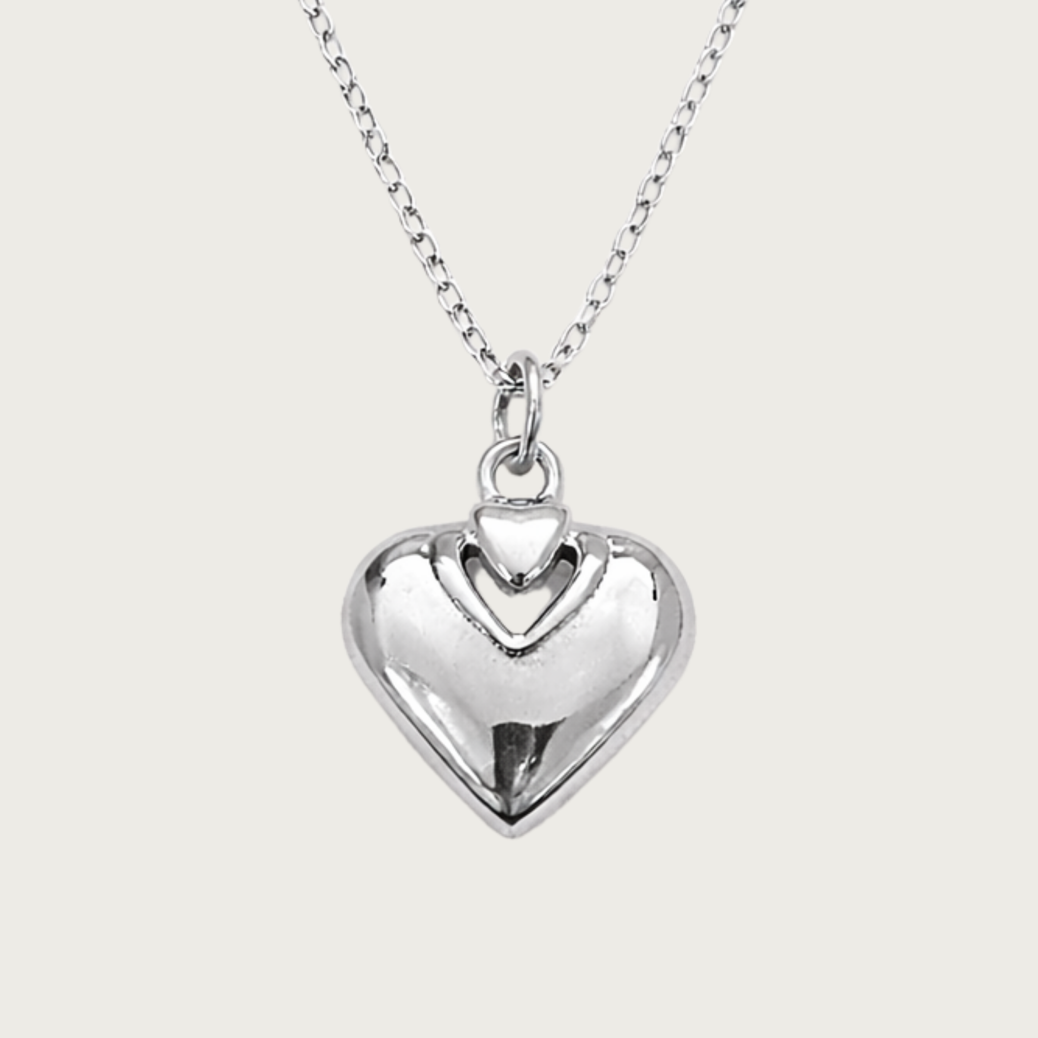 Silver heart-shaped pendant on a chain