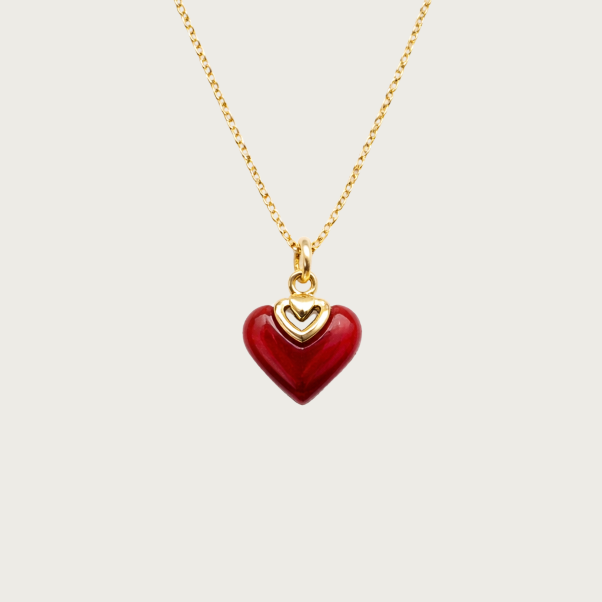 Red heart-shaped pendant on a gold chain 