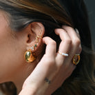 Model wearing gold snake ear cuff by MILA GIRALDO styled with studs and rings — modern ear cuffs Australia look.