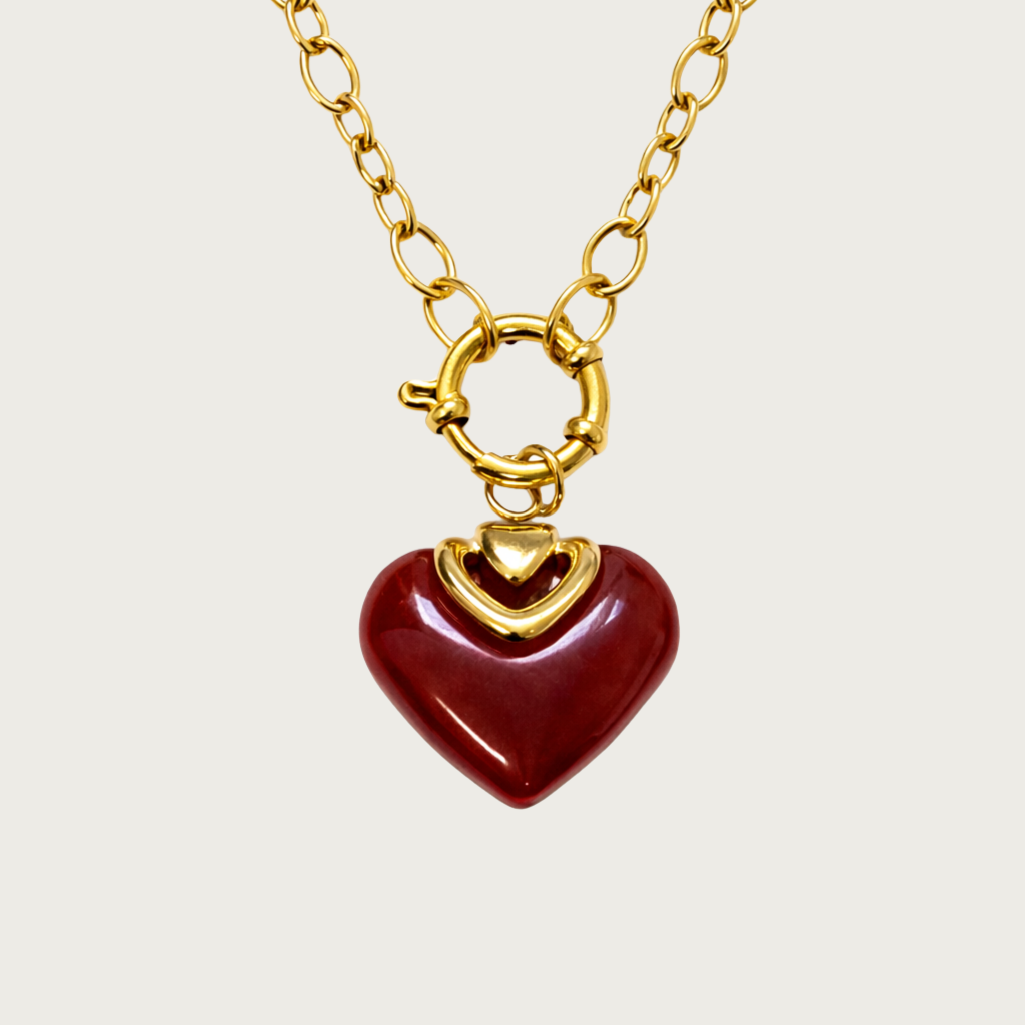 Gold necklace with a red heart pendant 