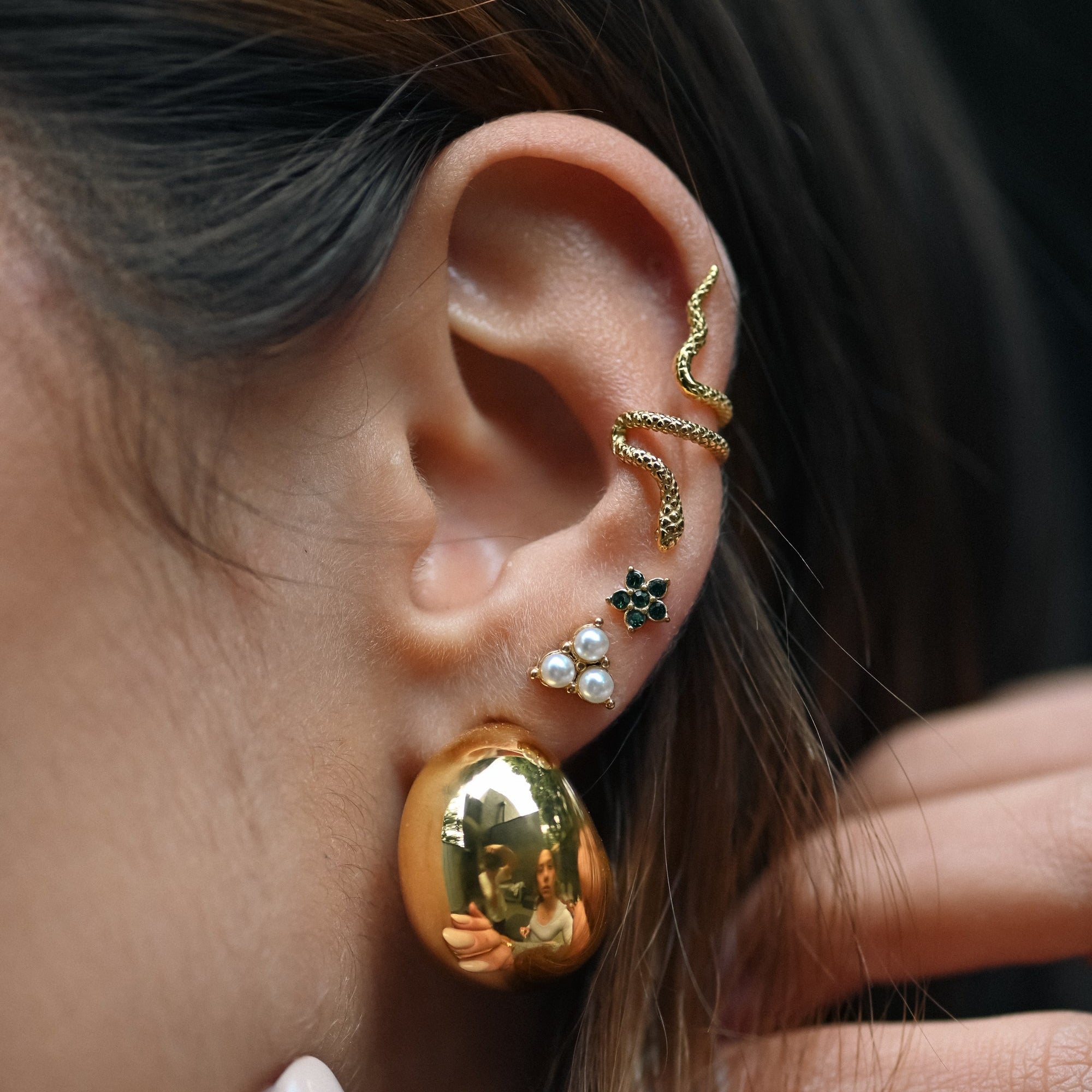 Model wearing Mila’s Flori Green Mini Studs in gold, styled with an ear cuff and two stacked stud earrings — a vibrant, minimalist jewellery look.