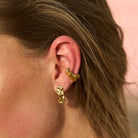 Model wearing 18k Gold PVD Mini Maria Stud Earrings styled with sculptural ear cuffs, creating a refined minimalist ear stack and modern everyday look by Mila Giraldo.