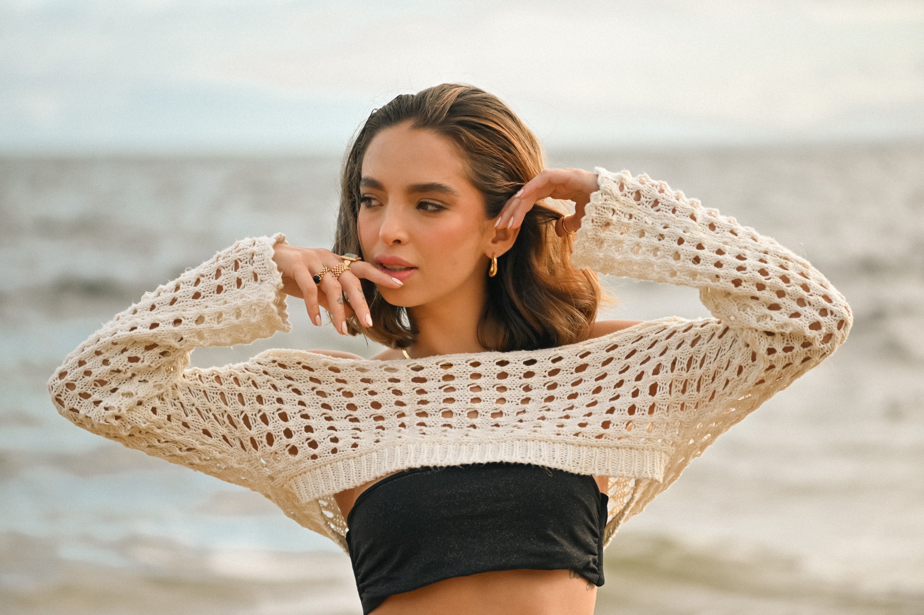 Wavy Square Hoop Earrings – 18k Gold PVD Plated Stainless Steel – Styled on Model With Stacked Rings – Sculptural Wavy Square Hoops in Lifestyle Shot – Mila Giraldo Jewellery Australia